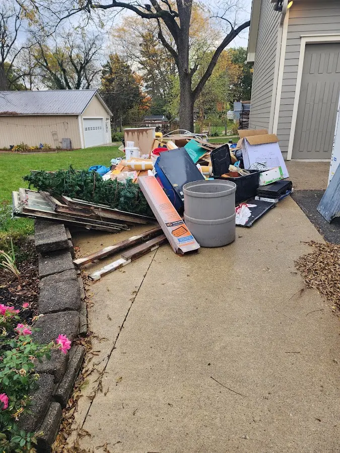 Dumpster being loaded with debris for 3 Yard Dumpster Rental in Crossett